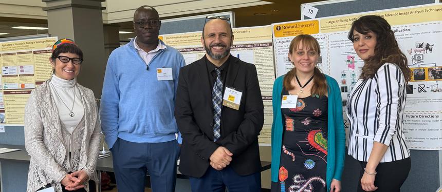 Faculty from the Shreiber School of Veterinary Medicine stand in front of their research posters
