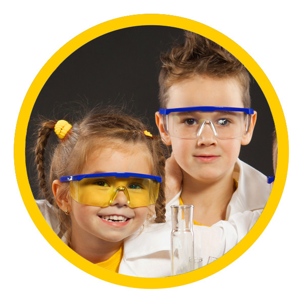 Smiling elementary-aged school children in science lab gear